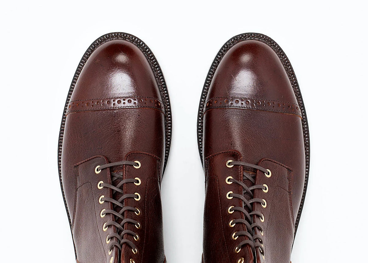 perforated cap toe service boot in Crimson Kudu with polished brass eyelets