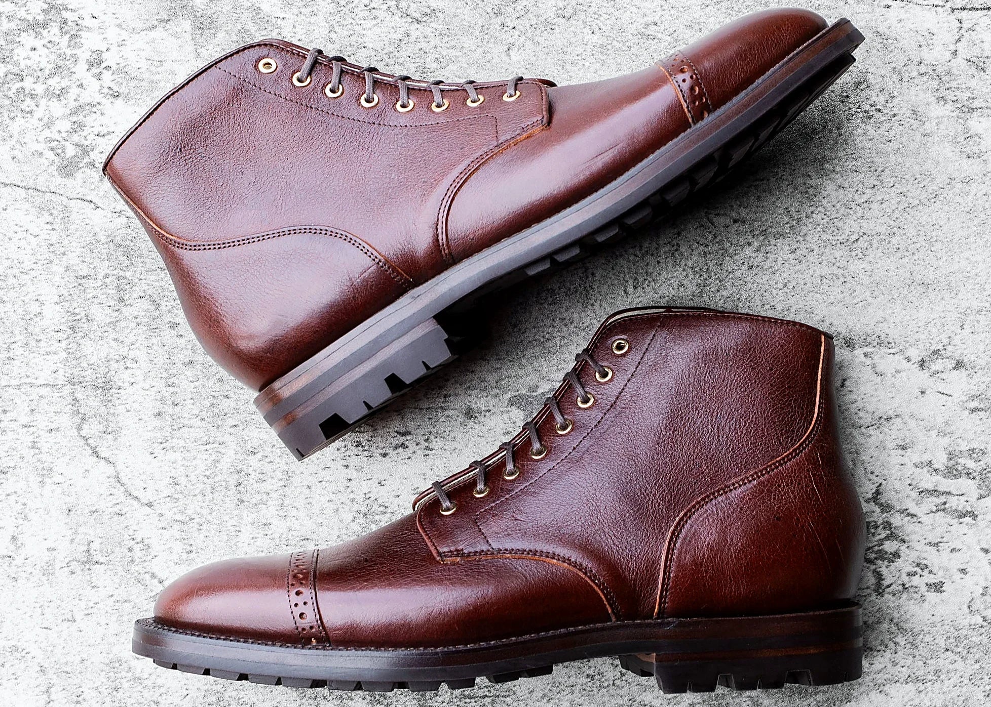 Crimson perforated cap toe service boot in Kudu, set on a lug rubber outsole