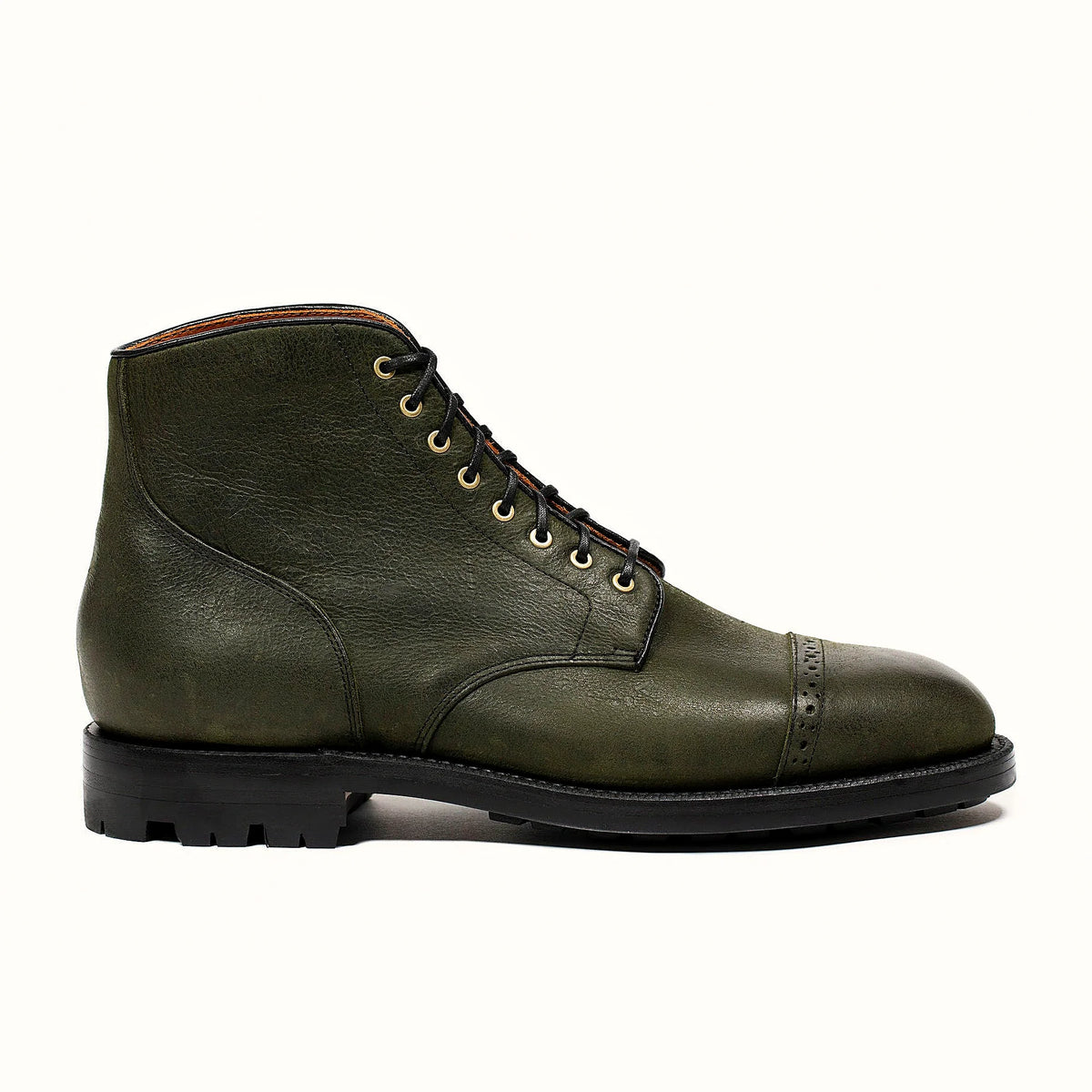 Forest green perforated cap toe service boot in Kudu, set on a lug rubber outsole