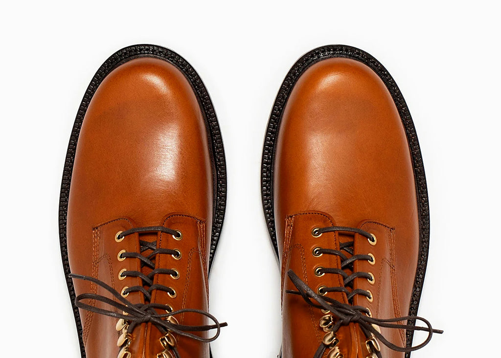 Saddle tan plain toe boot in Minerva, set on a lug rubber outsole