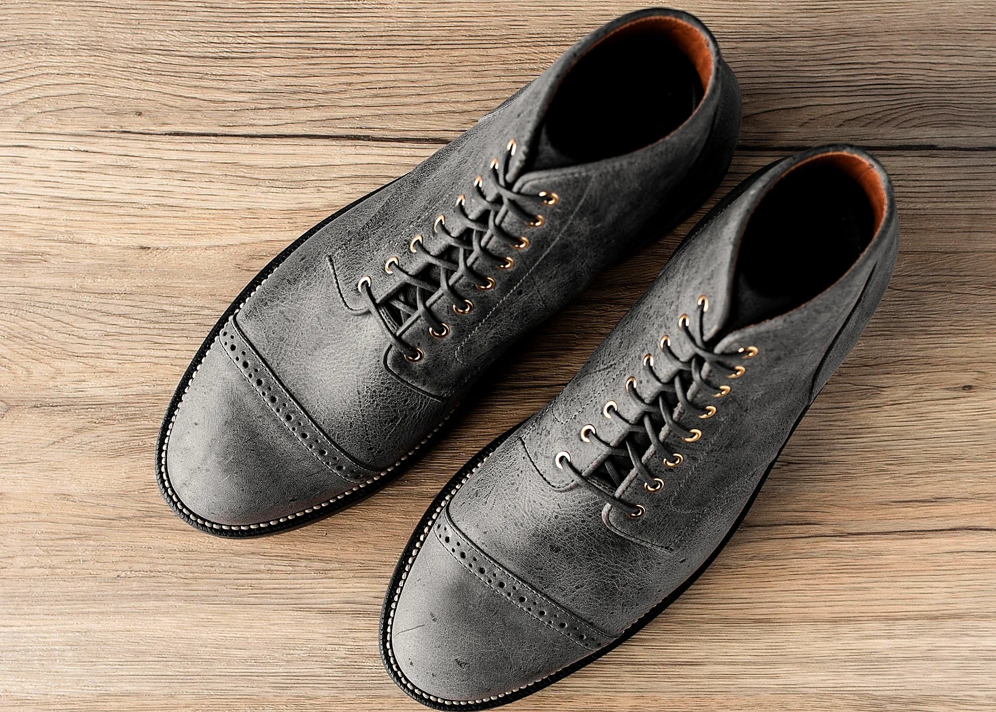 perforated cap toe service boot in Storm grey Waxed Kudu with polished brass eyelets